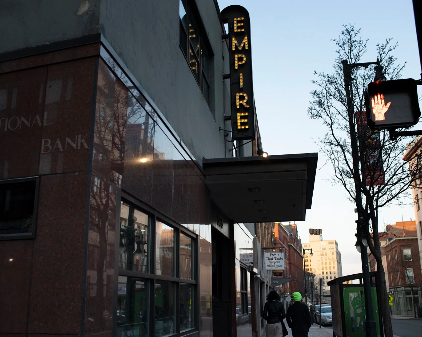 Stylized view of the Empire Comedy Club showroom with stage lighting and audience seating.